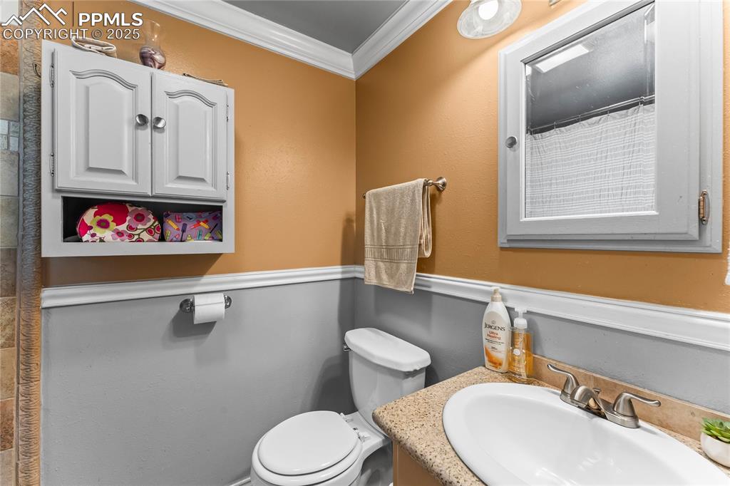 Image 15 of 30: Full bathroom featuring ornamental molding and vanity