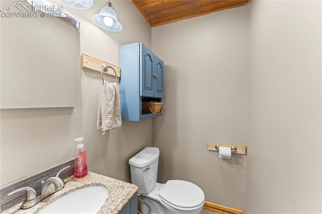 Image 19 of 30: Bathroom with vanity and wooden ceiling