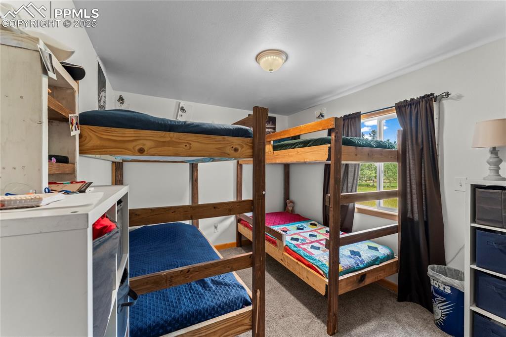 Image 21 of 30: Bedroom featuring light colored carpet