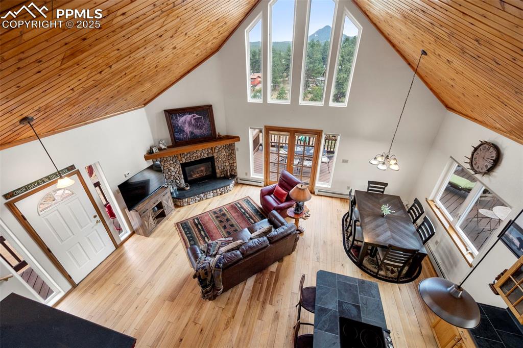 Image 17 of 38: Living area featuring high vaulted ceiling, wooden ceiling, hardwood / wood