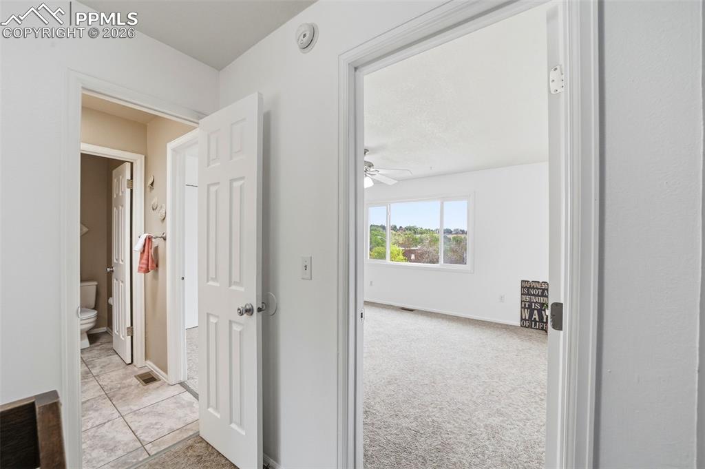 Image 16 of 36: Upper hallway to bath and Primary