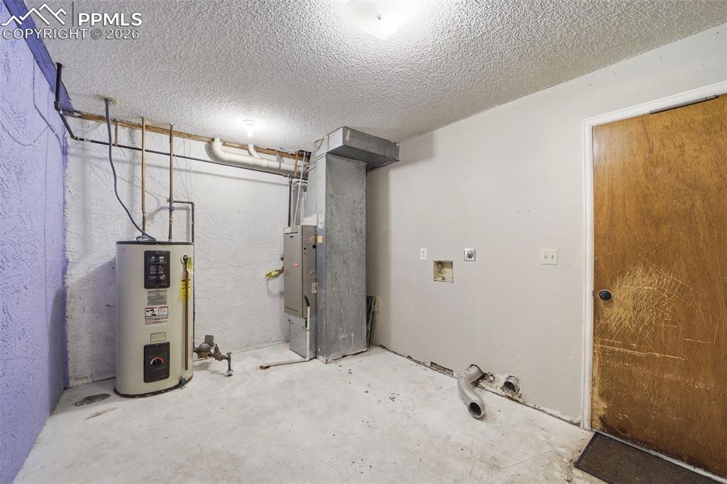 Image 26 of 36: Garage entrance, laundry, extra storage