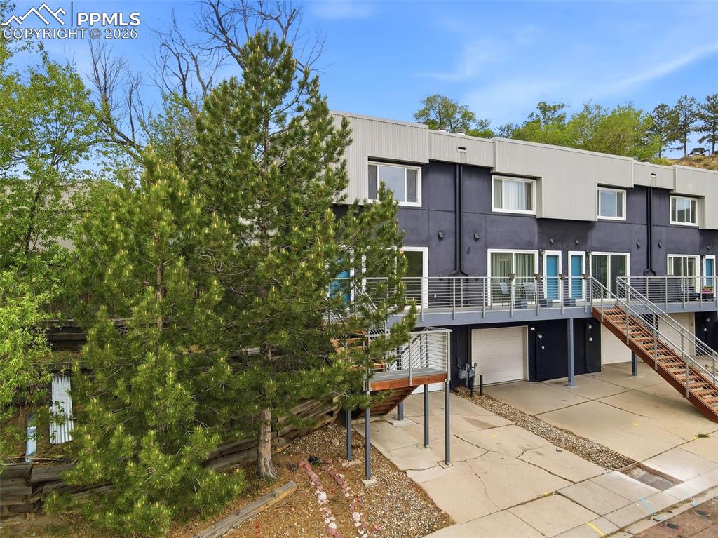 Image 31 of 36: Modern townhouse exterior featuring a multi-level design, contrasting dark 