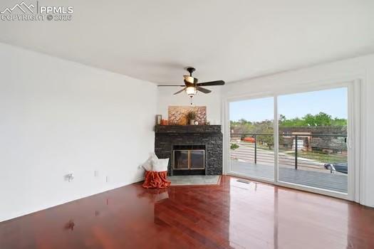 Image 8 of 36: Spacious living area featuring rich wood-finish flooring, a contemporary ce