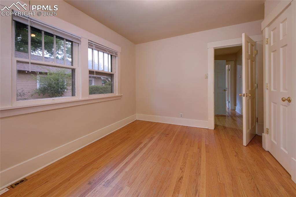 Image 13 of 28: Empty room featuring baseboards and light wood finished floors