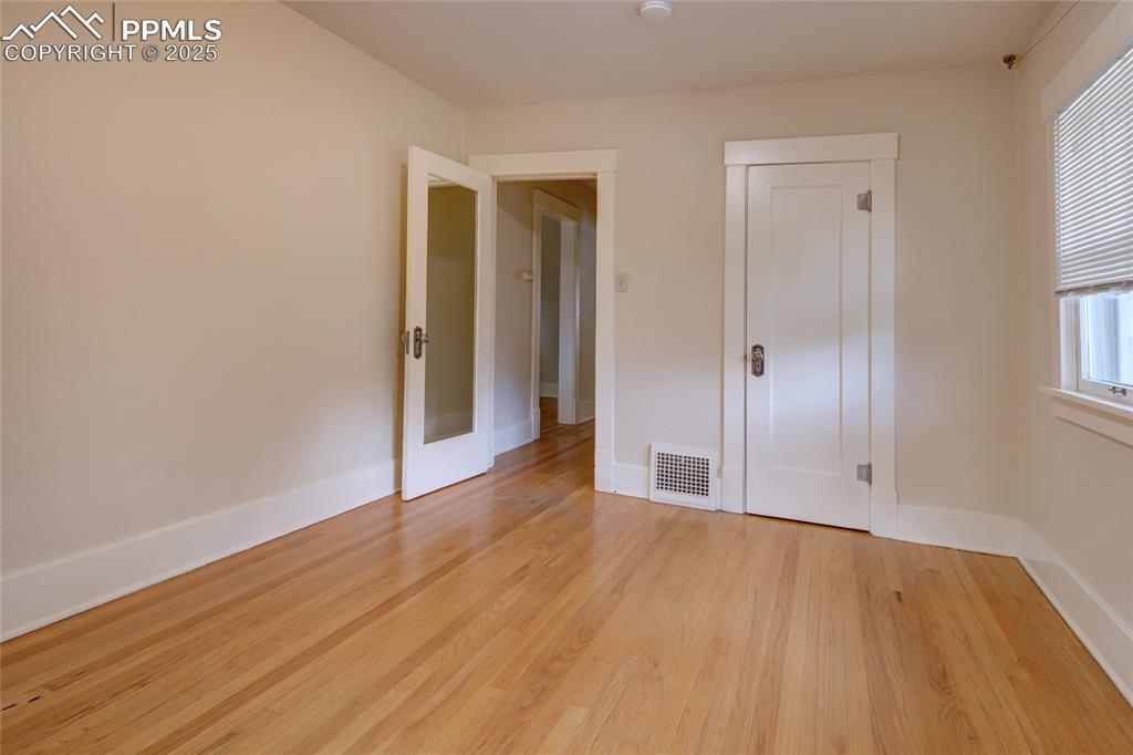 Image 15 of 28: Unfurnished bedroom with light wood finished floors and a closet