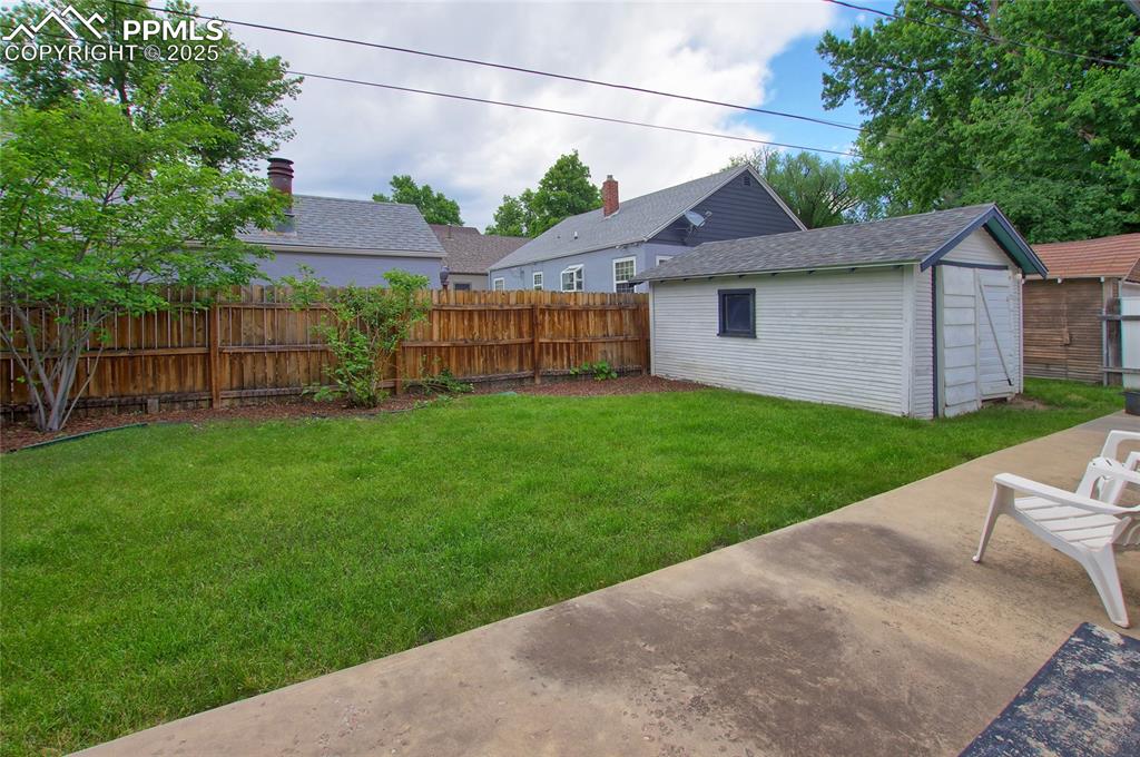 Image 23 of 28: View of yard with a patio area and an outbuilding