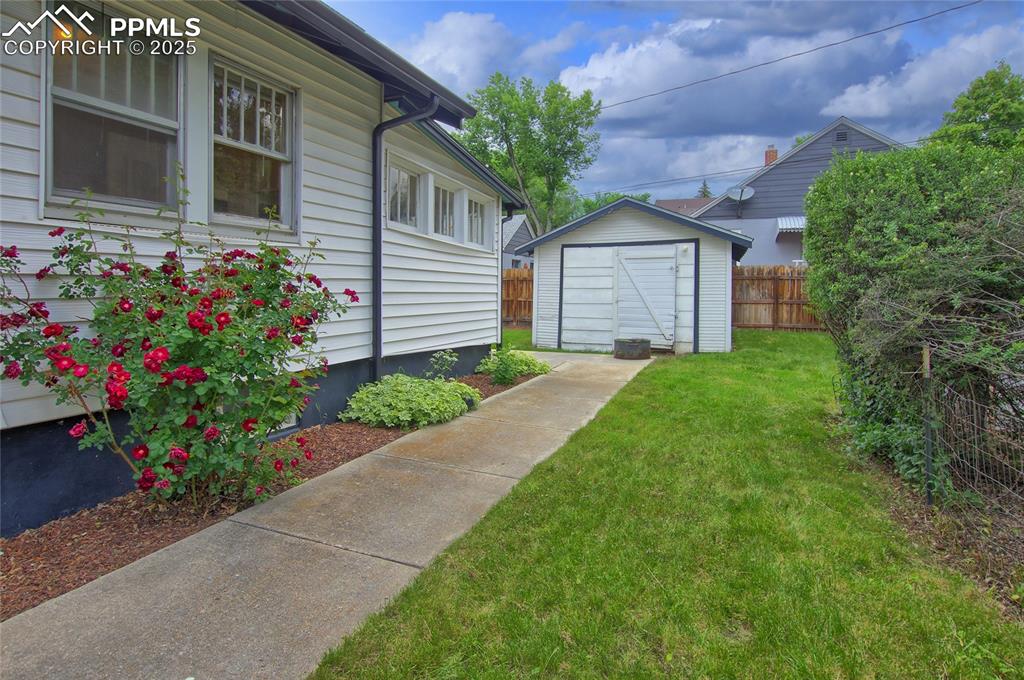 Image 24 of 28: View of yard with a storage unit