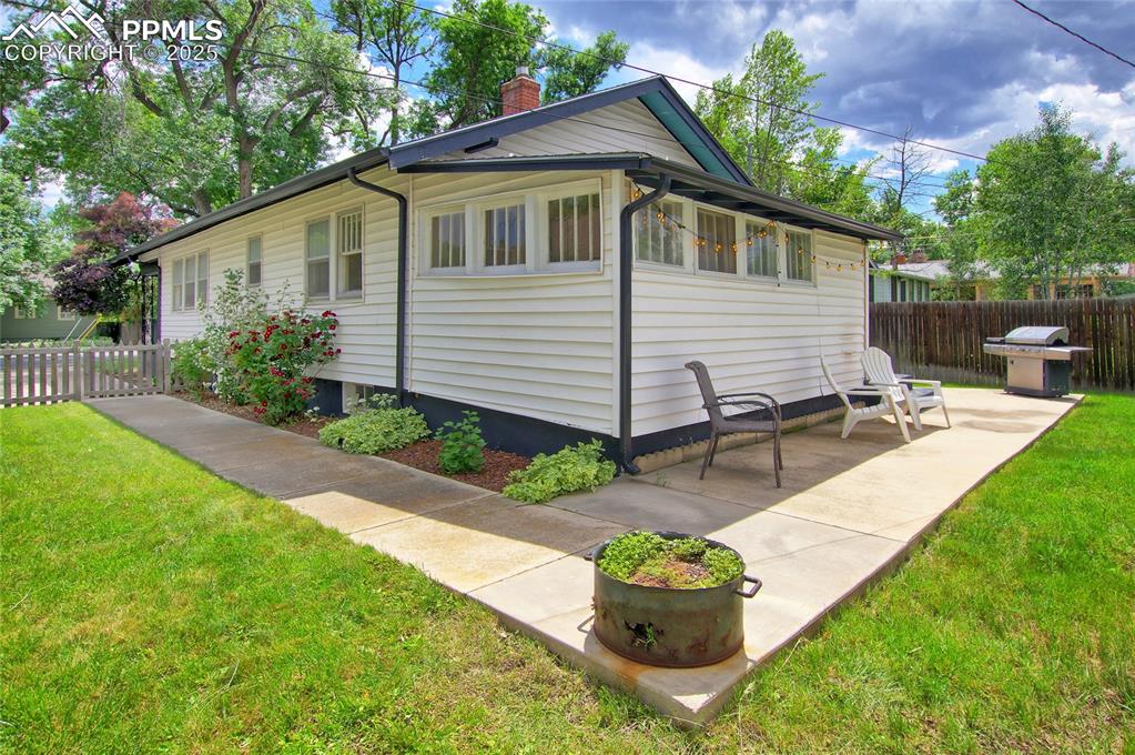 Image 26 of 28: View of property exterior featuring a chimney and a patio area