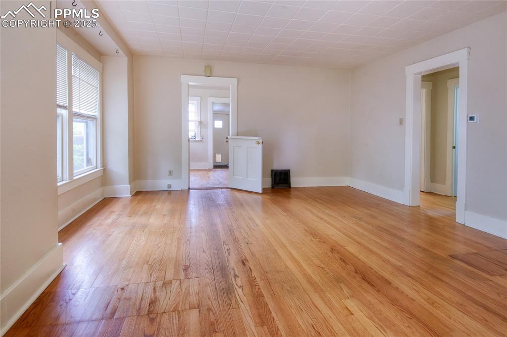 Image 7 of 28: Spare room featuring plenty of natural light and light wood-style flooring