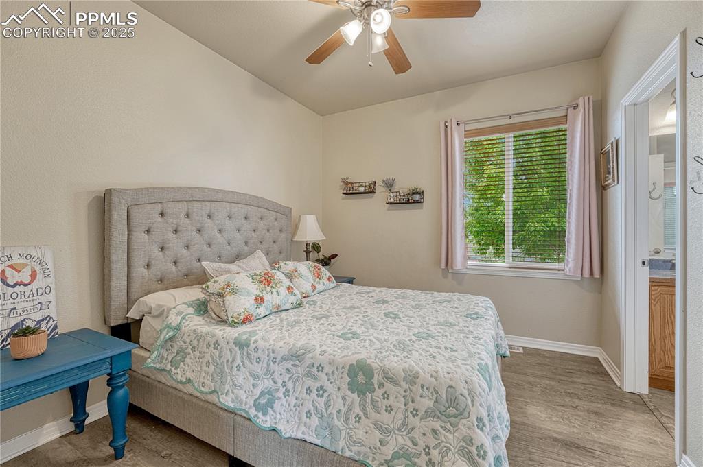Image 20 of 47: Bedroom with light wood-style floors and ceiling fan