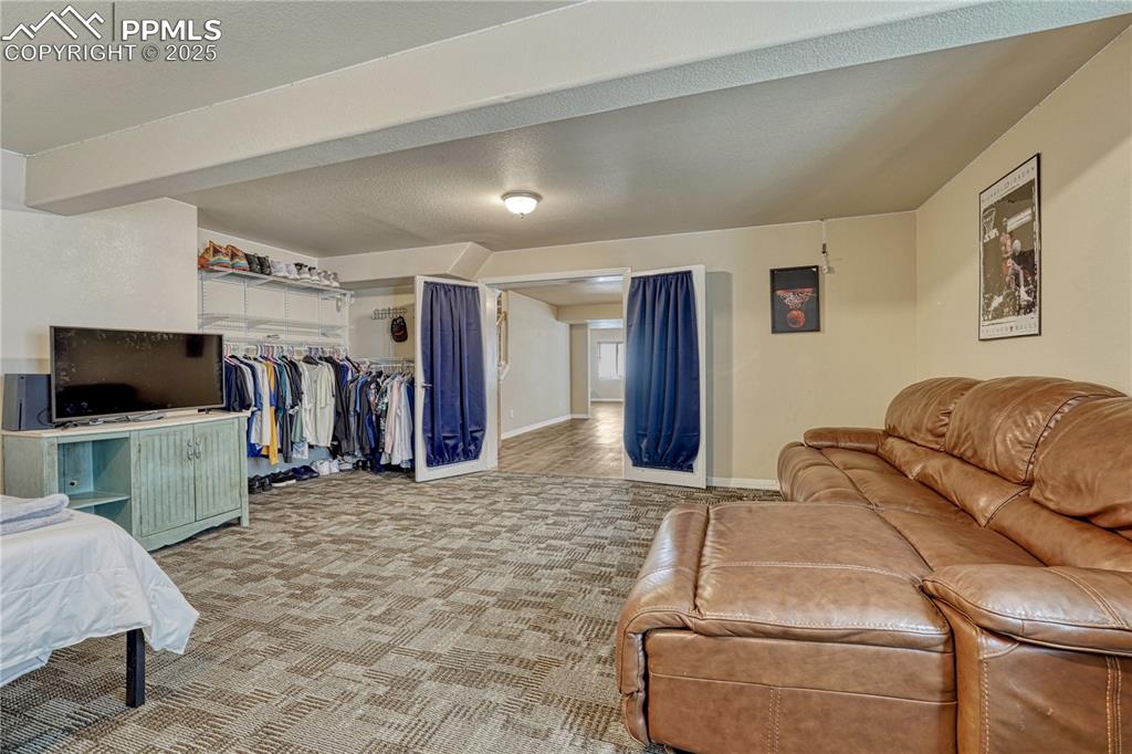 Image 28 of 47: Bedroom featuring carpet, a closet, and a textured ceiling
