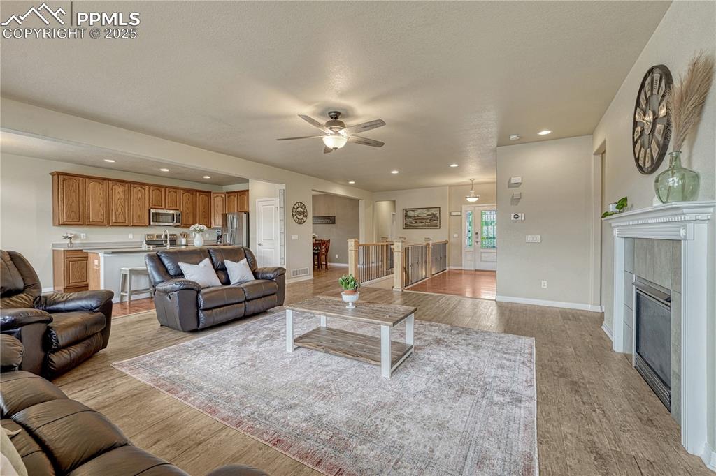 Image 3 of 47: Living room featuring recessed lighting, light wood-type flooring, a firepl