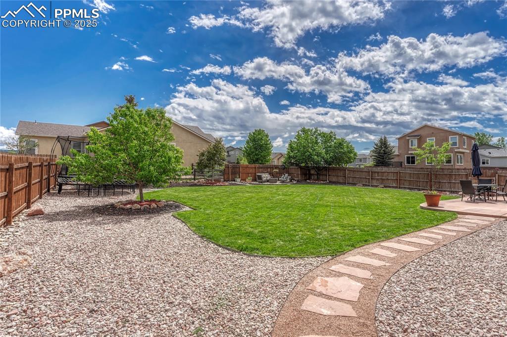 Image 34 of 47: Fenced backyard with a patio area and a residential view