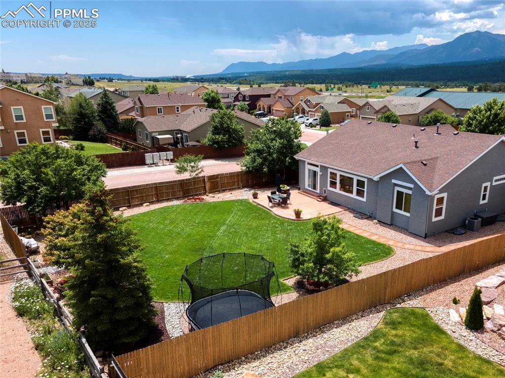 Image 42 of 47: Aerial perspective of suburban area with a mountainous background