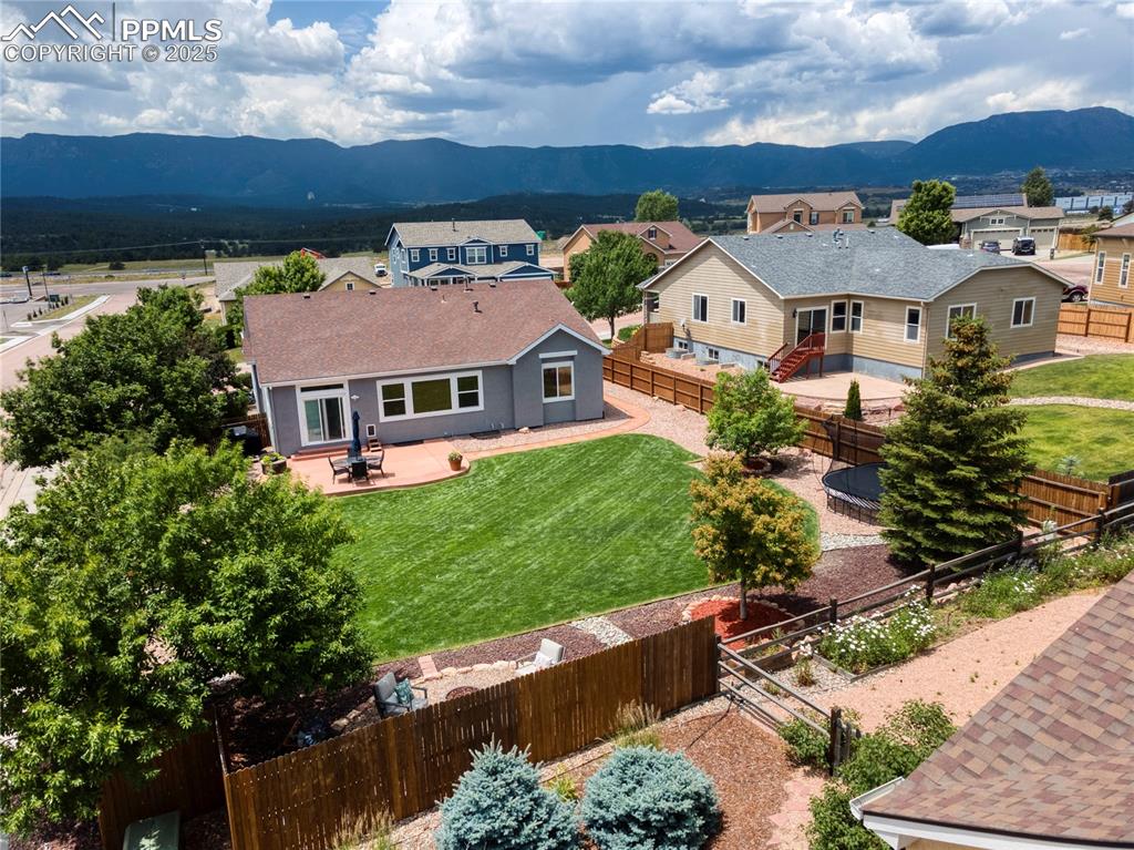 Image 43 of 47: Aerial view of residential area with a mountainous background
