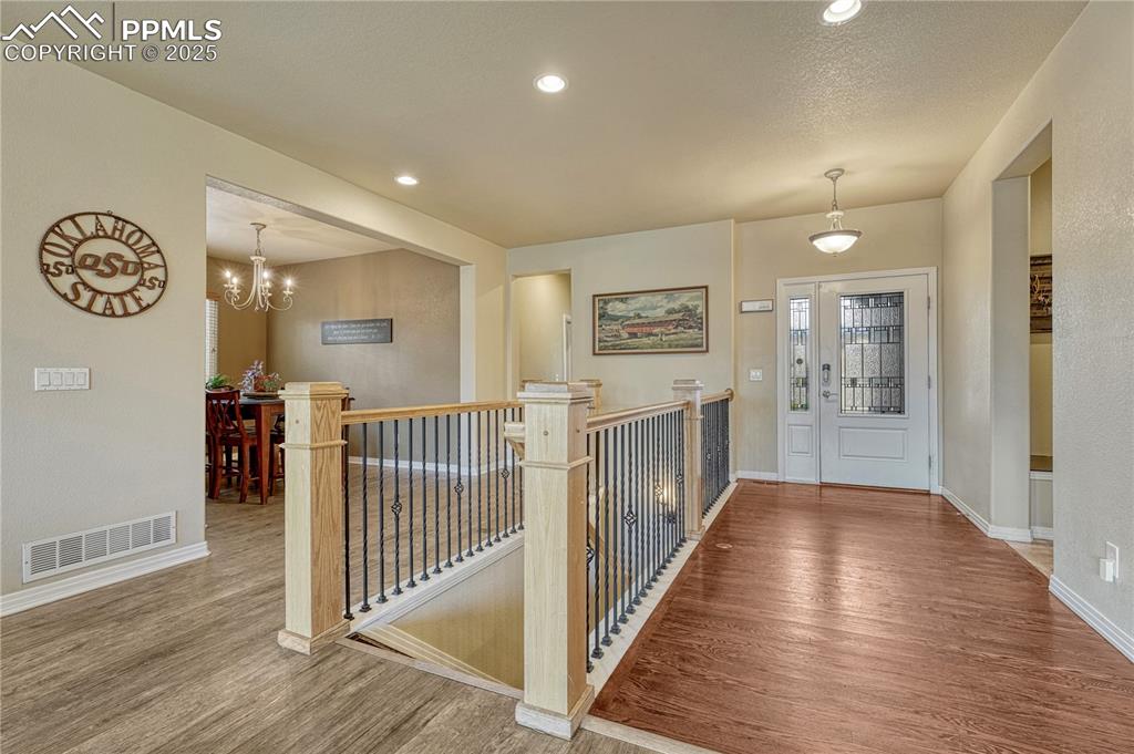 Image 9 of 47: Foyer with recessed lighting, wood finished floors, and a chandelier