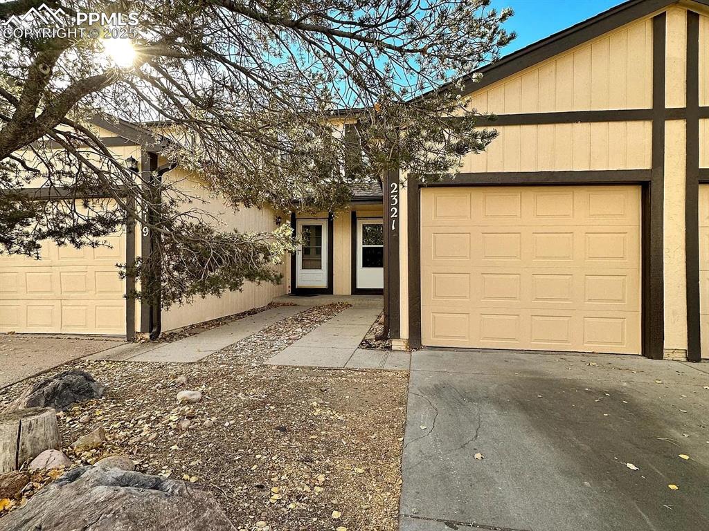 Image 1 of 23: View of front of property with an attached garage, driveway, and stucco sid