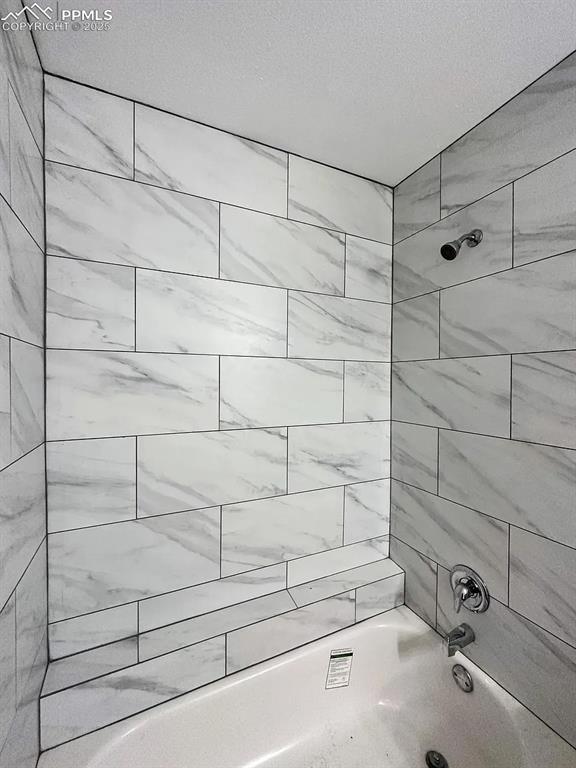 Image 14 of 23: Bathroom featuring tub / shower combination