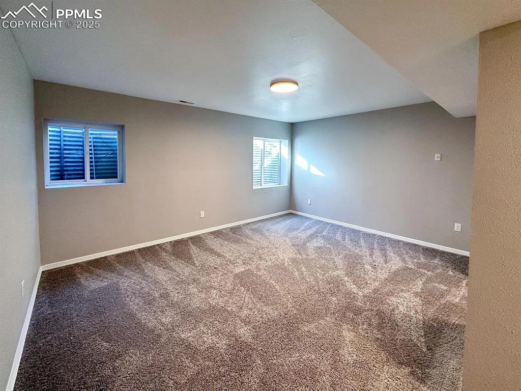 Image 19 of 23: Carpeted spare room with visible vents and baseboards