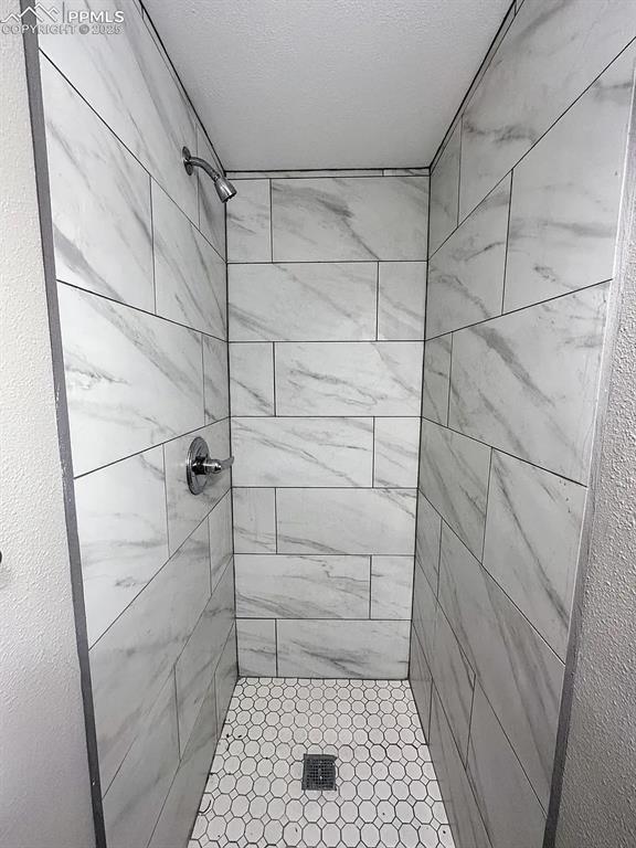 Image 22 of 23: Full bath featuring tiled shower