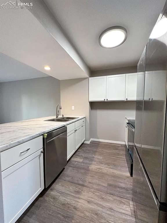 Image 5 of 23: Kitchen featuring stainless steel dishwasher, dark wood finished floors, wh