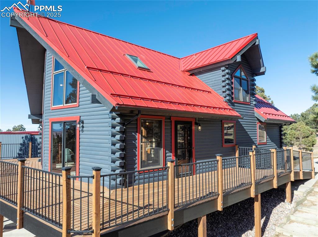 Image 2 of 50: Walk out to the deck from double slider doors, and multiple areas from the 