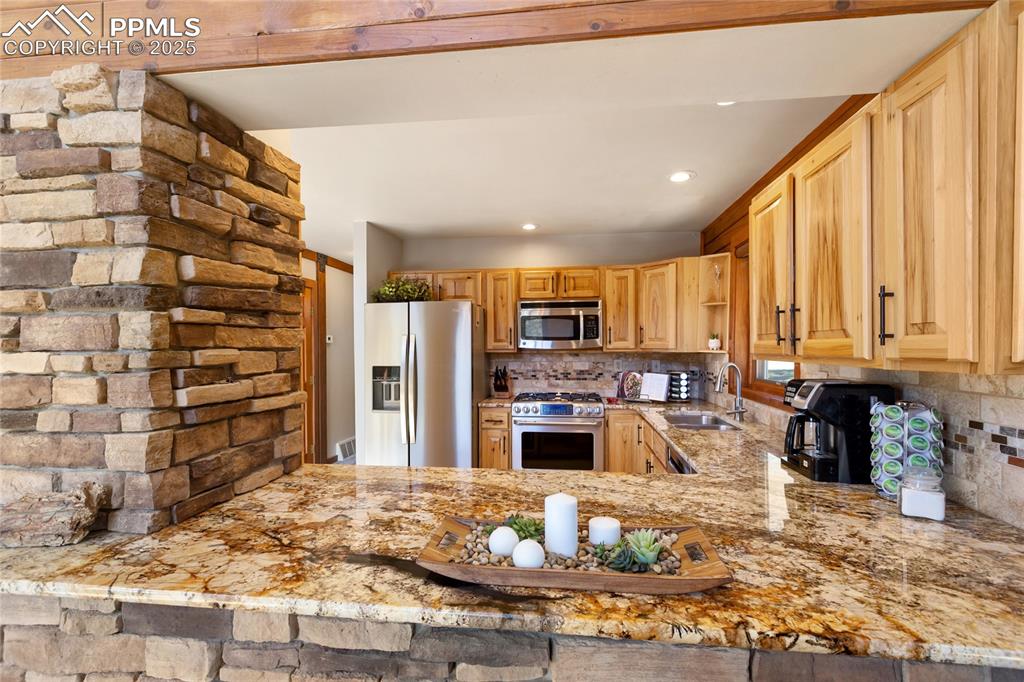 Image 22 of 50: Quartz counters, stainless steel, hickory cabinets, stone accents, open to 