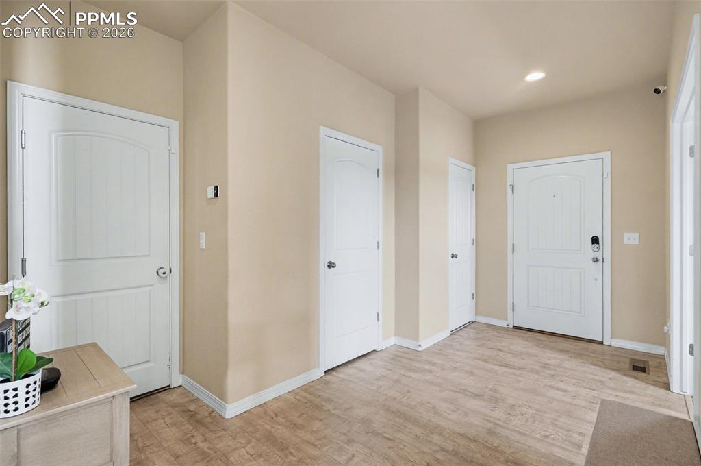 Image 12 of 40: Foyer featuring light wood-finish flooring, neutral wall tones, white trim,