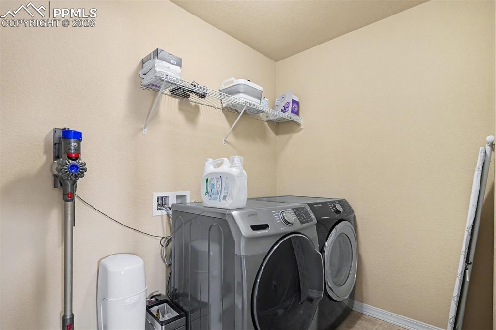 Image 30 of 40: Dedicated utility area featuring neutral-toned walls