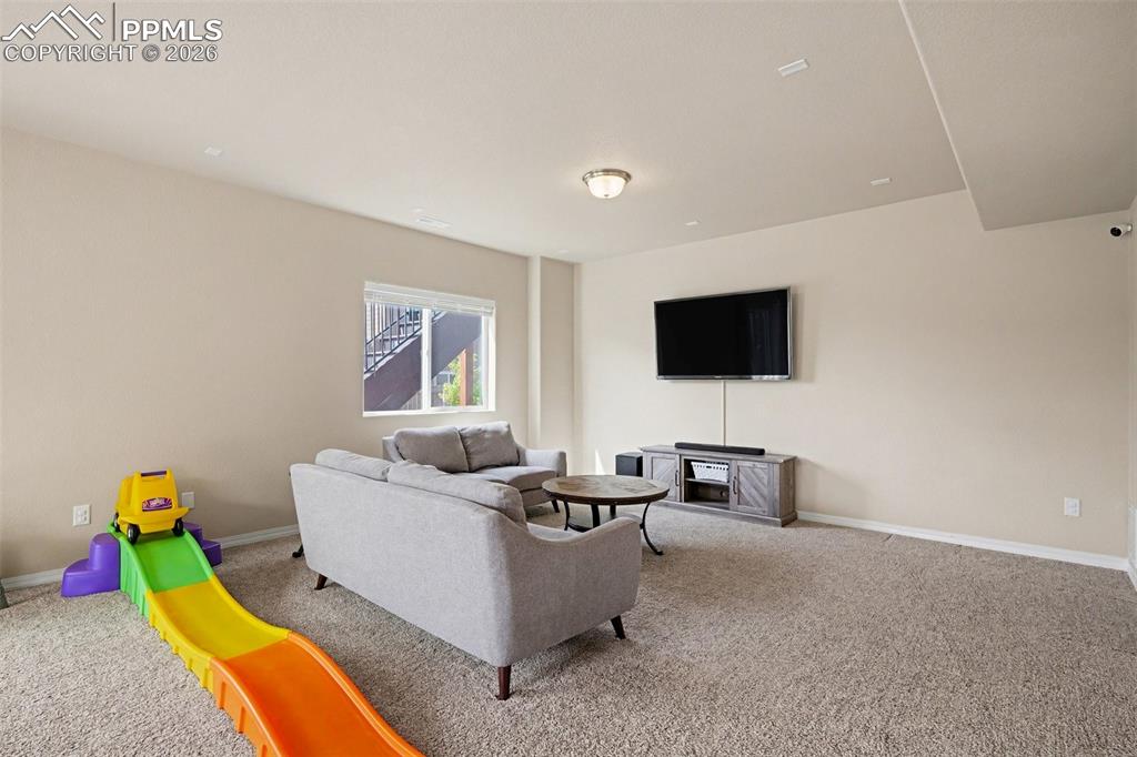 Image 34 of 40: Carpeted living space with neutral painted walls and a recessed window