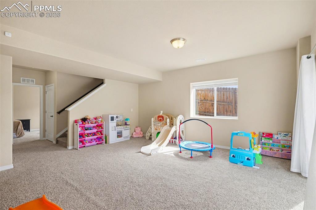Image 36 of 40: Spacious lower level featuring plush carpeting, neutral wall tones, a reces