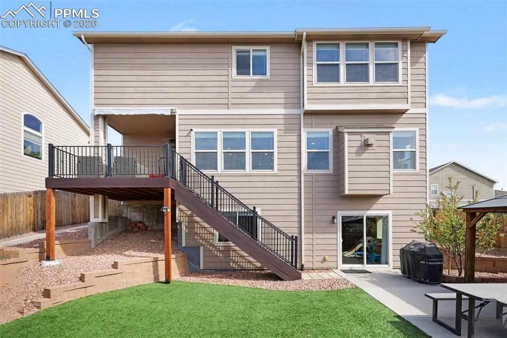 Image 40 of 40: Rear exterior featuring a multi-level composite deck with metal railings an