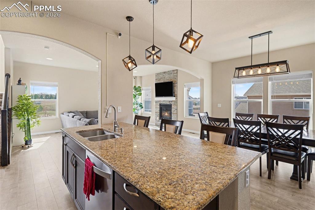 Image 9 of 40: Kitchen island featuring a double-basin stainless steel sink, pull-down fau
