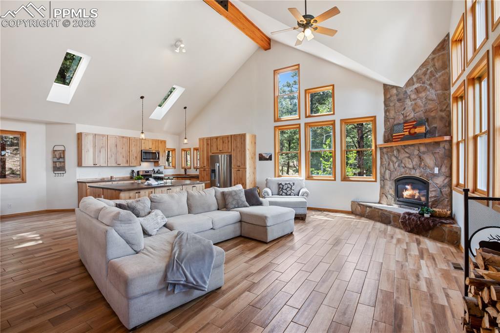 Image 9 of 34: With loads of windows and a beautiful fireplace!