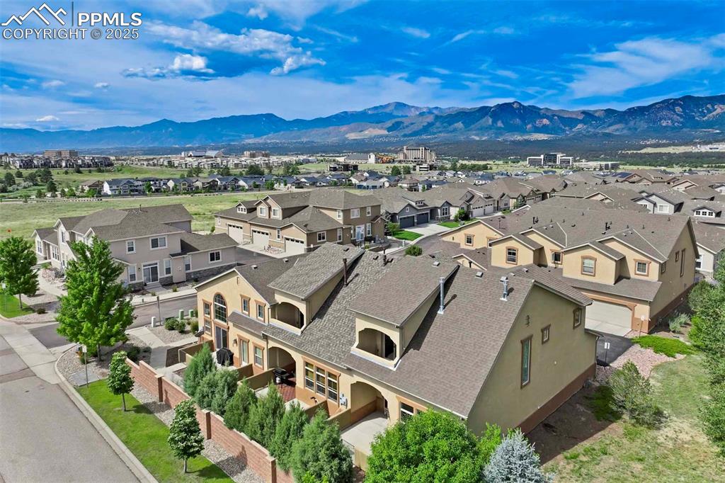 Caption: Aerial perspective of suburban area featuring mountains