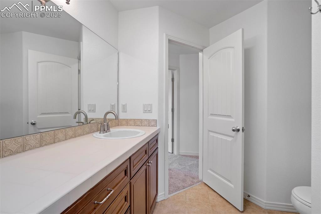 Image 32 of 50: Bathroom featuring vanity and tile patterned flooring