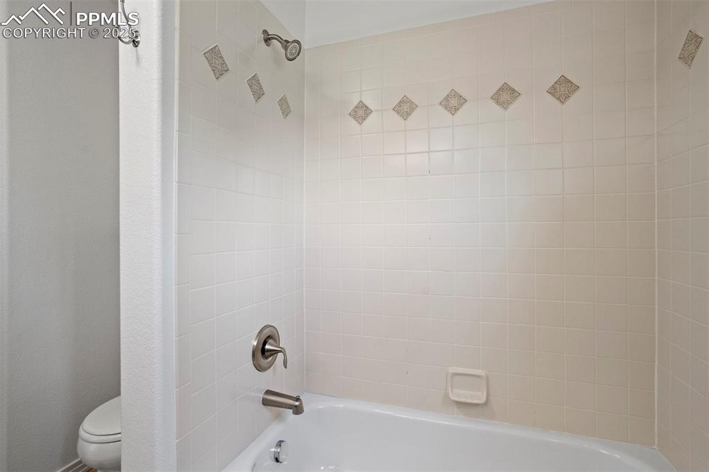 Image 33 of 50: Full bath with toilet and shower combination