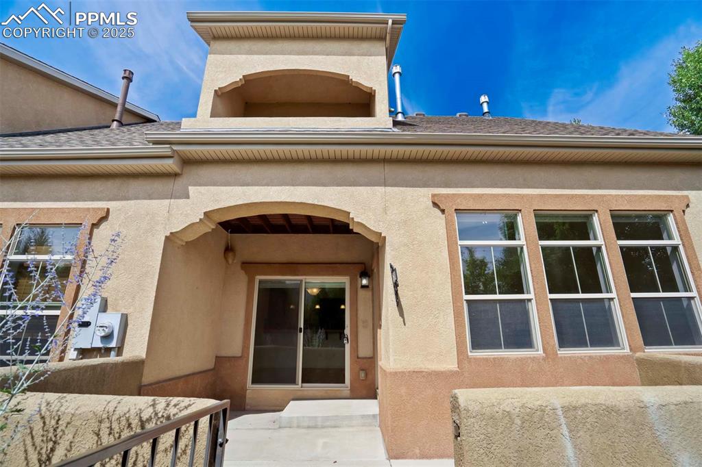 Image 40 of 50: View of exterior entry with stucco siding
