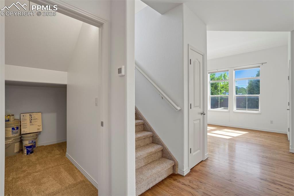 Image 41 of 50: Stairs featuring baseboards and wood finished floors