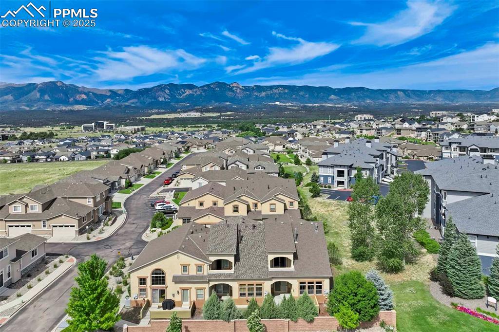 Image 43 of 50: Aerial perspective of suburban area featuring a mountain backdrop