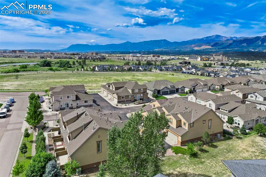 Image 44 of 50: Aerial perspective of suburban area featuring a mountainous background
