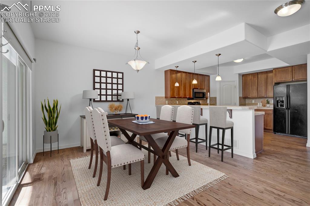 Image 6 of 50: Dining space featuring light wood-style floors and baseboards, virtually st