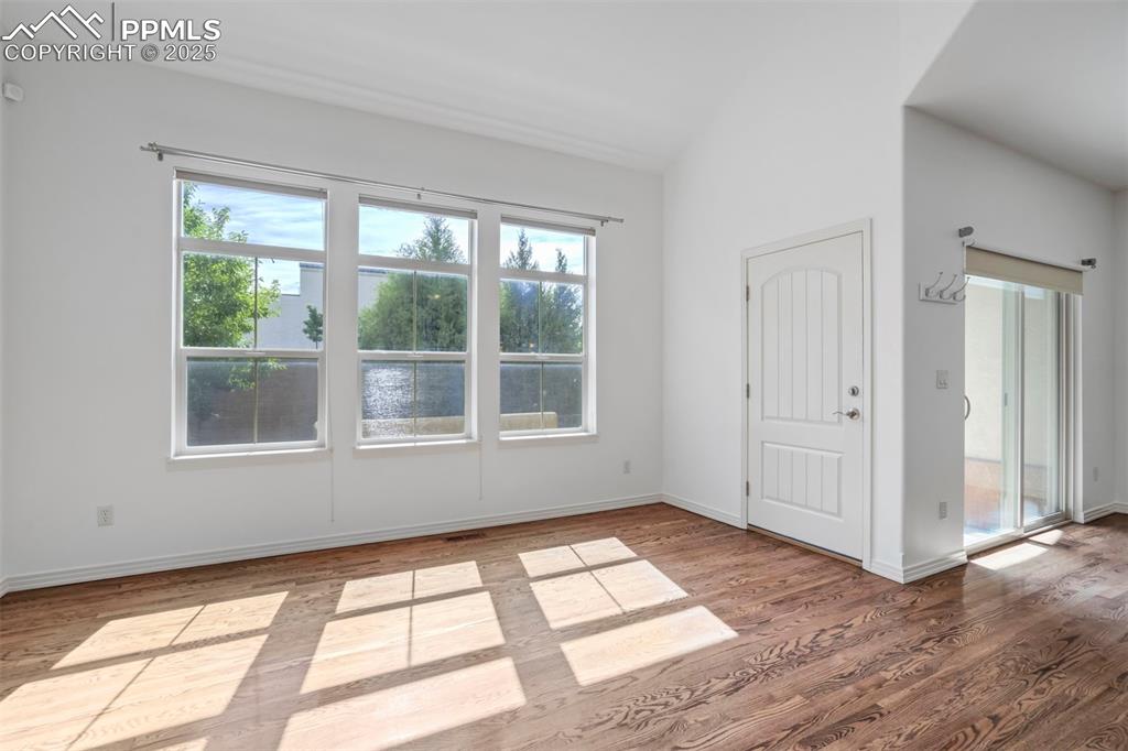 Image 7 of 50: Unfurnished room featuring plenty of natural light and wood finished floors
