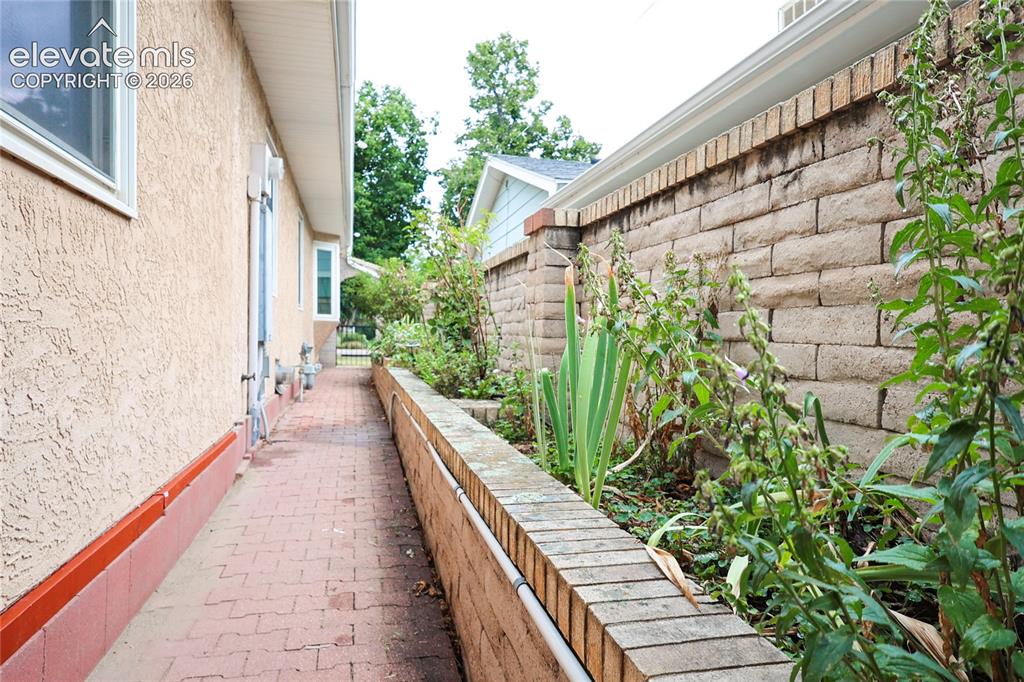 Image 38 of 40: Side yard with irrigated planters