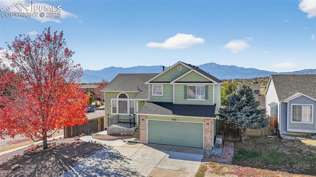 Image 3 of 30: View of front of property featuring roof with shingles, brick siding, concr