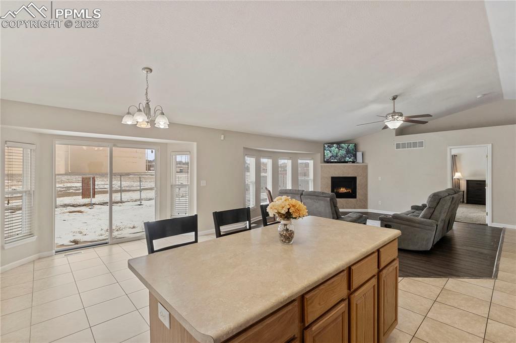 Image 8 of 36: Large windows and vaulted ceilings make the space feel open and airy
