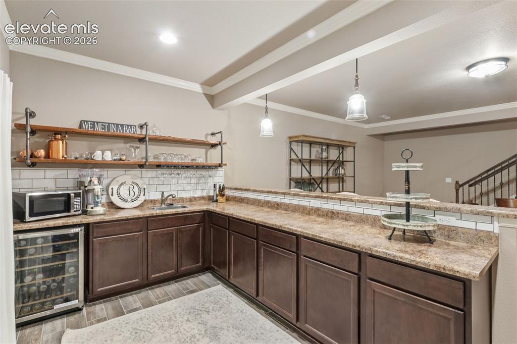 Image 21 of 40: Basement wet bar With plenty of space to add apartment sized refrigerator a