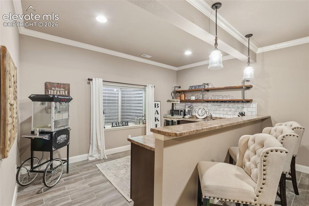 Image 22 of 40: Basement wet bar With plenty of space to add apartment sized refrigerator a