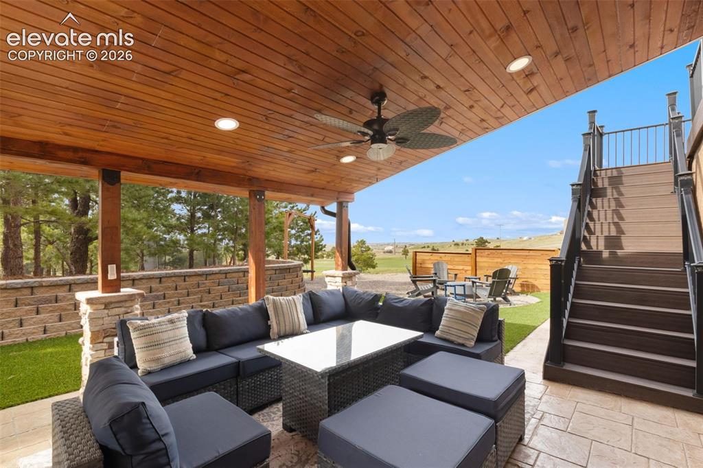 Image 32 of 40: Outdoor Entertainment area tv, outdoor speakers, hot tub, ceiling fan, rece